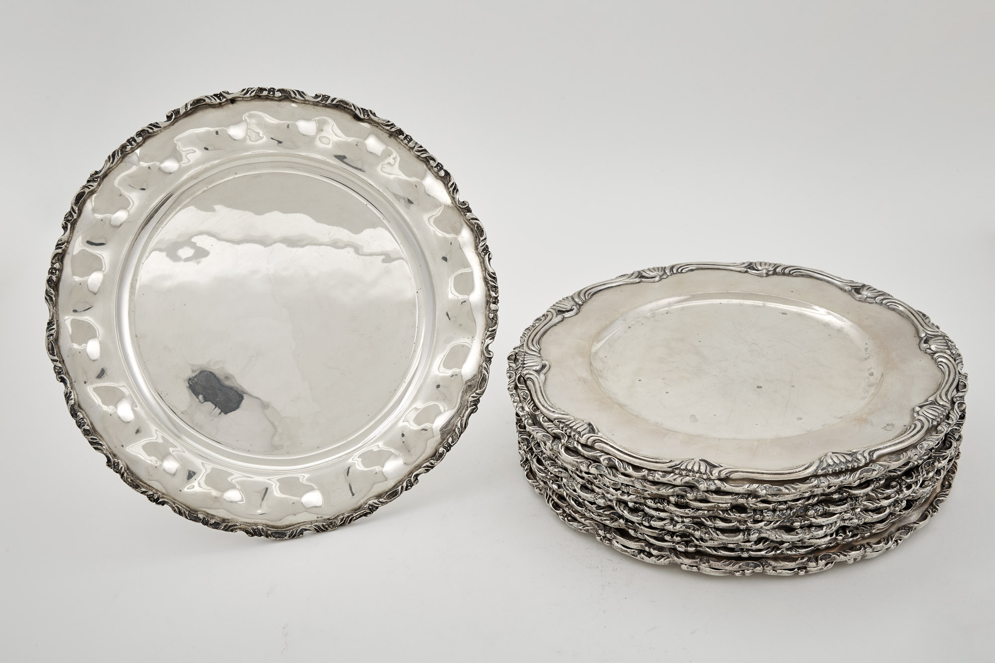 Lot image - Set of Twelve Mexican Sterling Silver Dinner Plates; Together with a Mexican Sterling Silver Dinner Plate