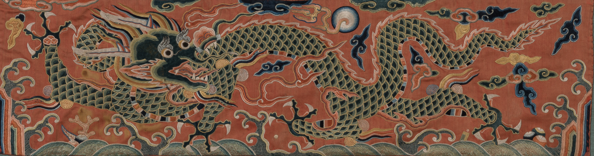 Lot image - A Chinese Embroidered Silk Fragmentary Dragon Panel
