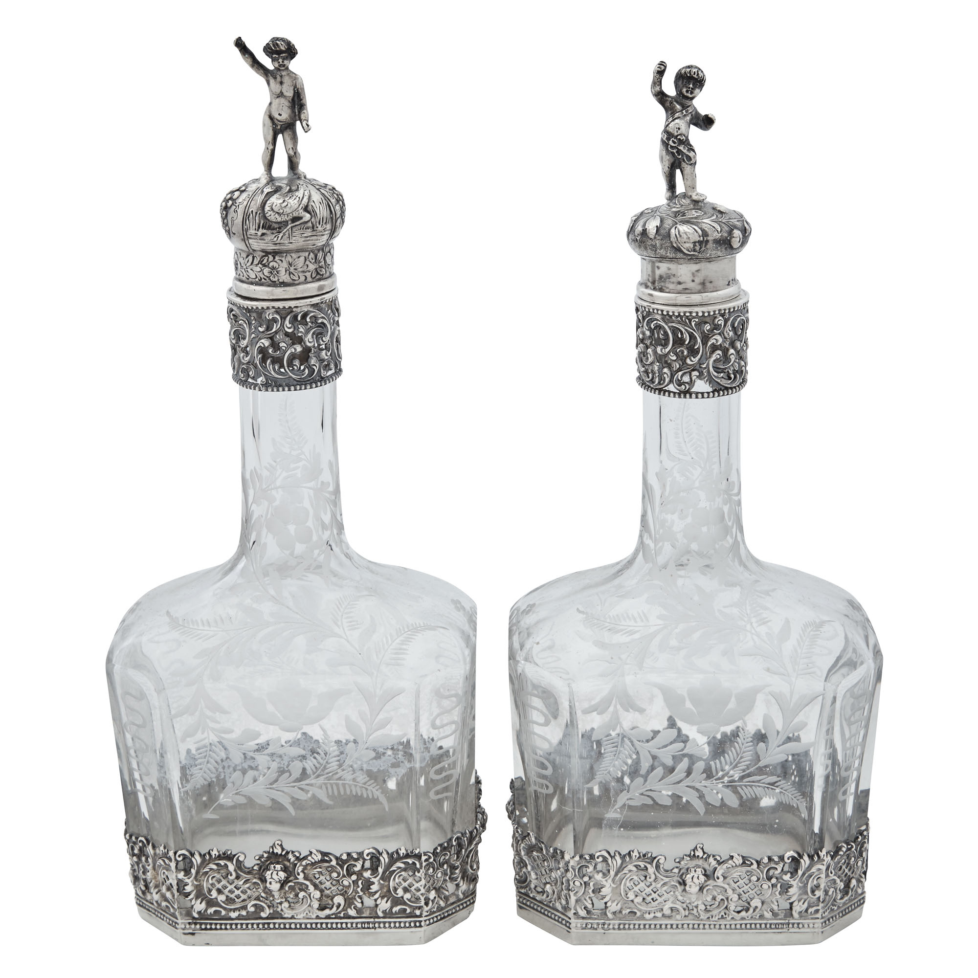 Lot image - Pair of Continental Silver Mounted Engraved Glass Decanters with Figural Stoppers