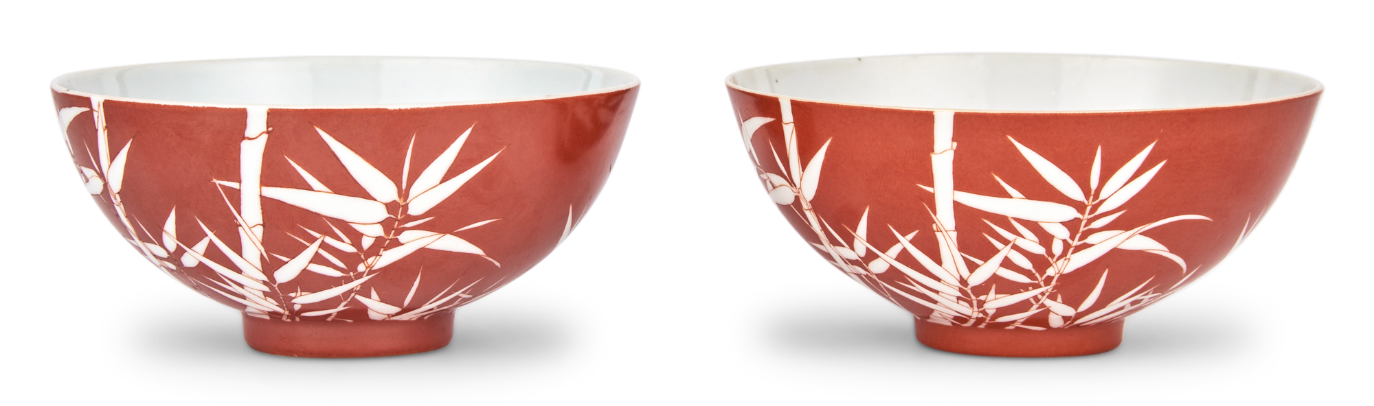 Lot image - Pair of Chinese Reverse-Decorated Coral Ground Bamboo Porcelain Tea Bowls