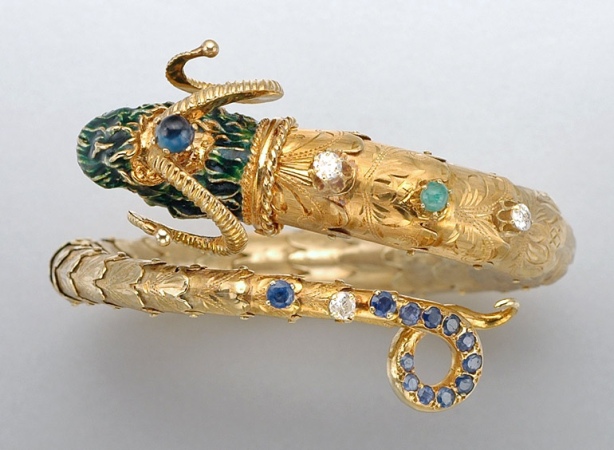 Lot image - Gold, Enamel, Sapphire, Synthetic Sapphire, Emerald and Diamond Rams Head Bangle