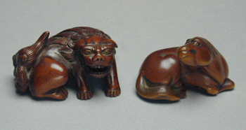 Lot image - Wood Netsuke of a Recumbent Horse and a Wood Netsuke of a Crouching Shishi First half of the 19th century, signed Namboku and