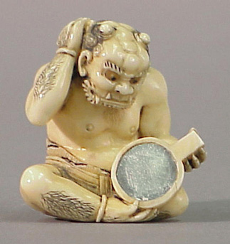Lot image - Good Japanese Ivory Okimono of an Oni Gazing into a Mirror
