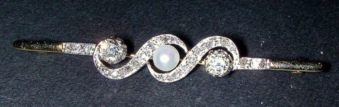 Lot image - Diamond and Natural* Pearl Bar Pin  The yellow gold pin having a platinum center section, of swirl design, set to the cente...