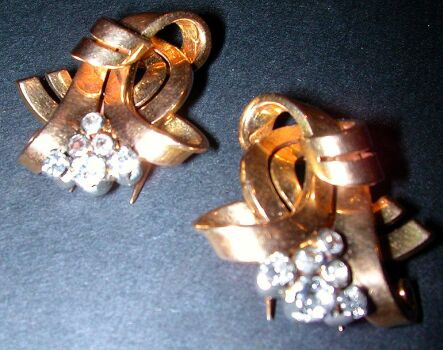 Lot image - Pair of Retro Gold and Diamond Clips  14 kt. yellow gold, of scrolled ribbon design, set altogether with six round old mine...