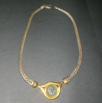 Lot image - Coin Pendant and Silver Chain  The yellow gold and silver chain, composed of flat curb links, centering an 18 kt. yellow go...