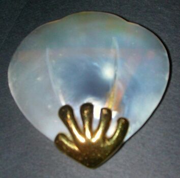 Lot image - Mother-of-Pearl Brooch  The 14 kt. yellow gold frame retaining a mother-of-pearl fan. Length 2 inches.