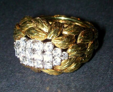 Lot image - Diamond Cluster Ring  The 18 kt. yellow gold mount of textured leaf design, set to the top with eighteen assorted round dia...