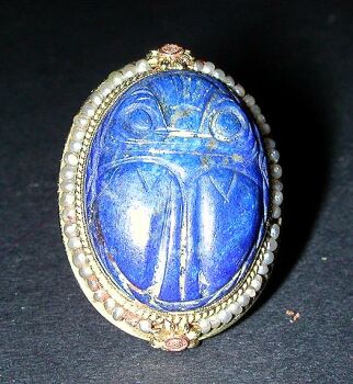Lot image - Antique Style Lapis Lazuli Scarab Ring   The 14 kt. yellow gold mounting having an oval top, set to the center with a lapis...
