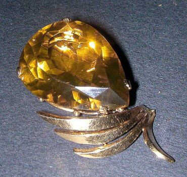 Lot image - Citrine Pendant  The 14 kt. yellow gold frame with plumed top, centering a pear-shaped citrine, approximately 30 cts.