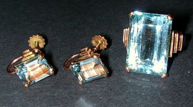 Lot image - Aquamarine Ring and Pair of Earclips  The 14 kt. yellow gold mount of step design, set to the center with an octagonal-cut...