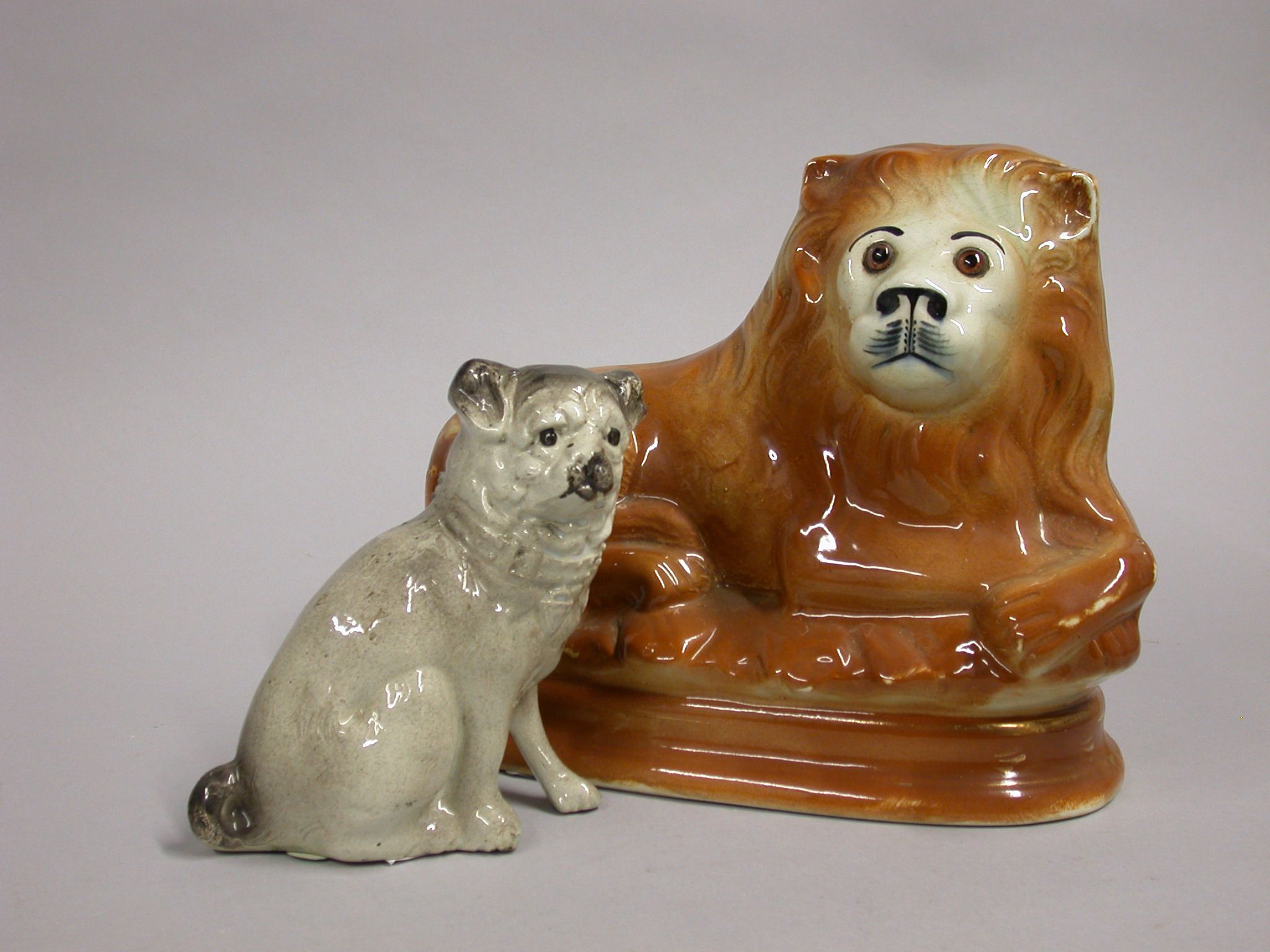 Lot image - Pair of Staffordshire Pottery Pug Dogs and Pair of Lions
