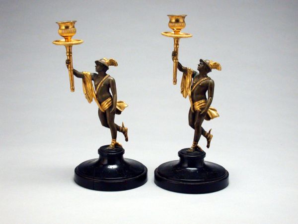 Lot image - Pair of Continental Gilt and Patinated-Metal Figural Candlesticks