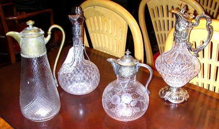 Lot image - Group of Four Silver Plated and Brass Mounted Glass Ewers