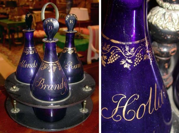 Lot image - French Gilt-Metal Mounted Black Painted Tantalus with Three Cobalt Blue Glass Decanters