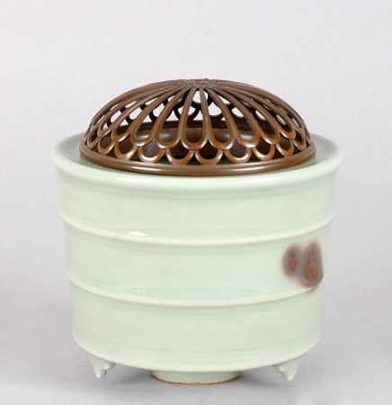 Lot image - Japanese Celadon Glazed Porcelain Tripod Censer; Together with a White Glazed Bottle Vase