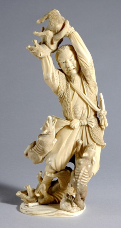 Lot image - Japanese Ivory Okimono of a Farmer Fighting off Wolves