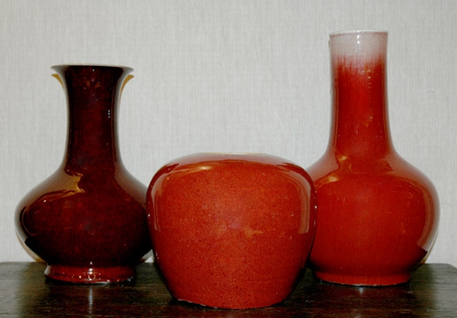 Lot image - Two Chinese Sang de Boeuf Glazed Vases; Together with a Chinese Flambe Glazed Porcelain Ginger Jar