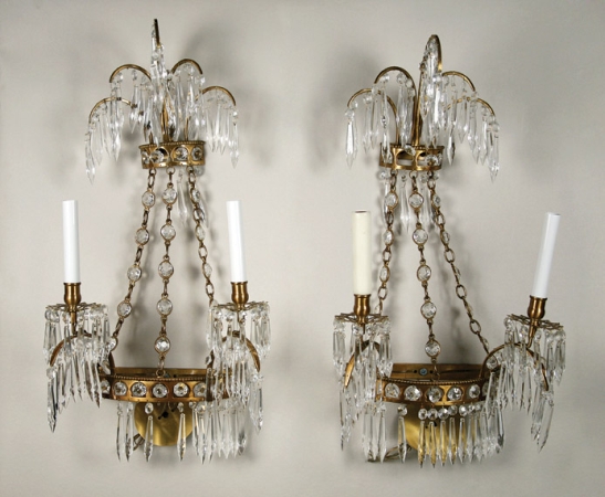 Lot image - Set of Four Baltic Neoclassical Style Gilt-Bronze and Cut Glass Two-Light Sconces