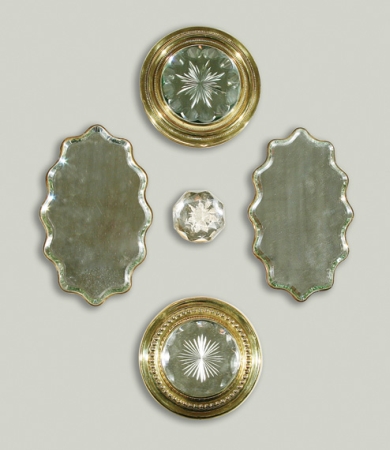 Lot image - Two Gilt-Brass Mirrored Reflectors; Together with a Pair of Mirrored Plaques and an Etched and Faceted Glass Paperweight