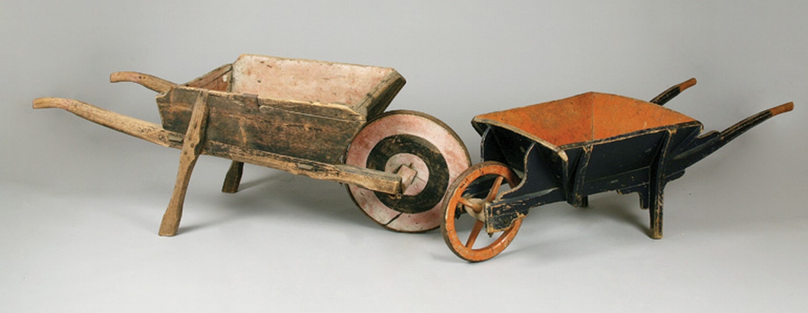 Lot image - Black and Red Painted Wheel Barrow; Together with a Faded Painted Wood Wheel Barrow