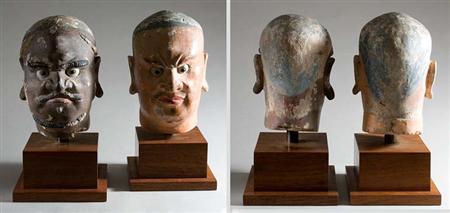 Lot image - Two Chinese Pigment Painted Stucco Heads of Guardians