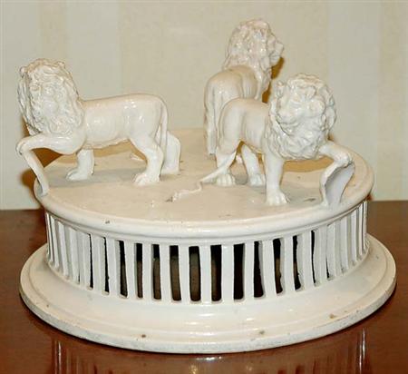 Lot image - Creamware Ceramic Centerpiece; T/w a Pair of Bookends, Lion Mask Jardiniere and a Frosted Glass Recumbent Lion on a Base