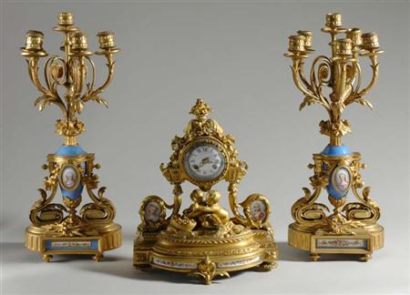 Lot image - Louis XVI Style Gilt-Bronze and Porcelain Figural Mantel Clock; t/w Similar Pair of Louis XVI Style Gilt Metal and Porcelain Candelabra