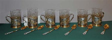 Lot image - Set of Six Russian Style Parcel Gilt and Niello Silver and Glass Tumbler Holders; Together with a Set of Six Russian Style Cloisonne Enameled Silver Teaspoons
