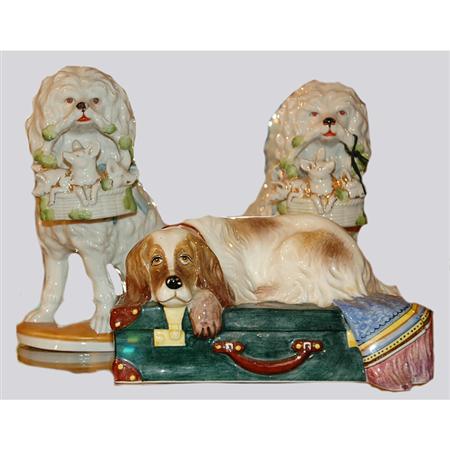 Lot image - Pair of Porcelain Poodles Holding Baskets; Together with an Italian Pottery Spaniel Lying on a Suitcase