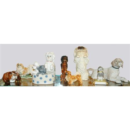 Lot image - Group of Nine Porcelain and Pottery Dogs