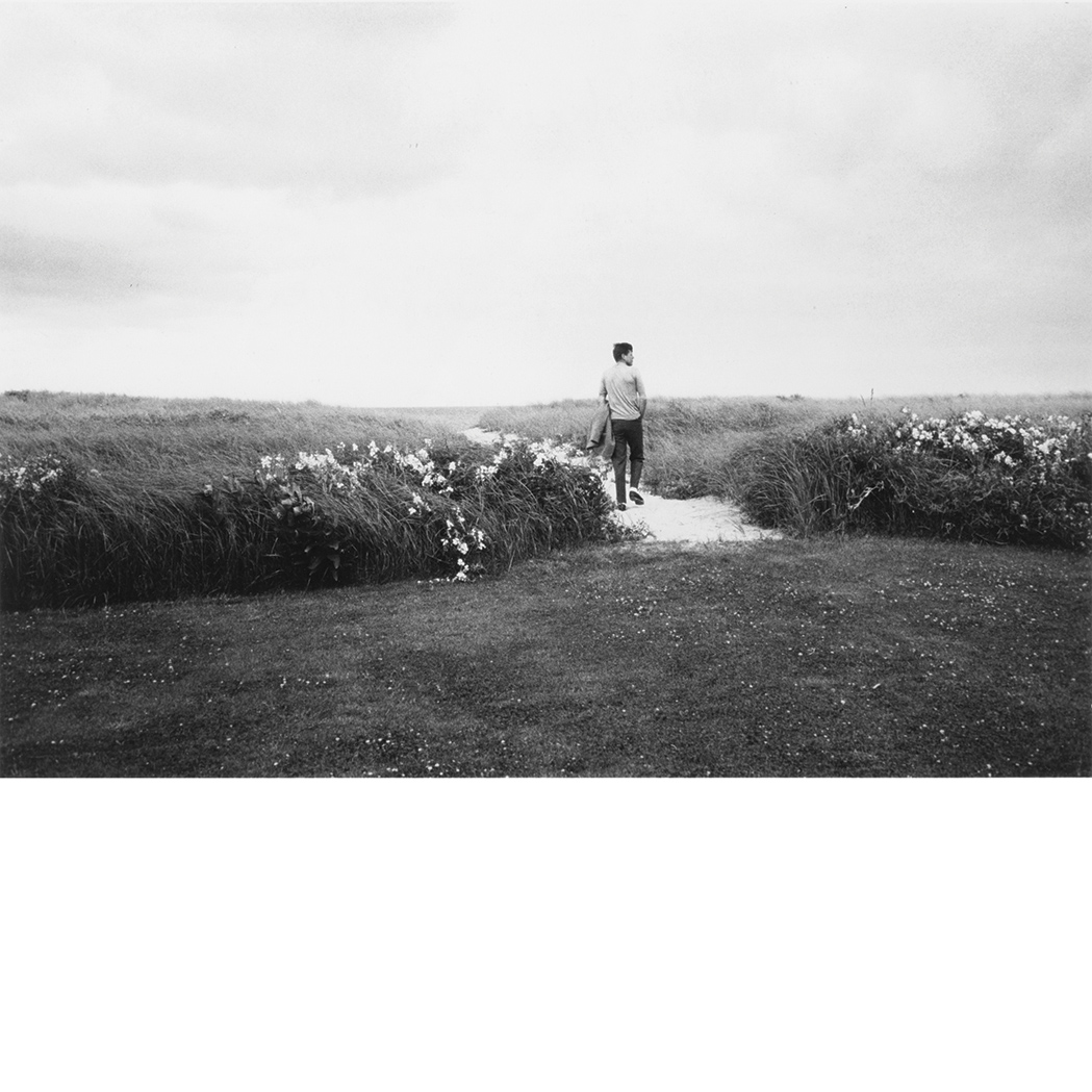 Lot image - [KENNEDY, JOHN FITZGERALD] SHAW, MARK. [Kennedy on the Dunes]. Gelatin silver print dry-mounted to board, 10 1/4 x 14 7/8 in...