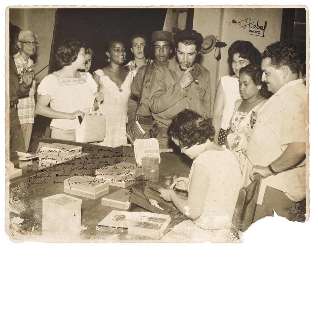 Lot image - GUEVARA, CHE  Photograph of Che [Ernesto] Guevara, cigar in hand, with a group of cigar workers