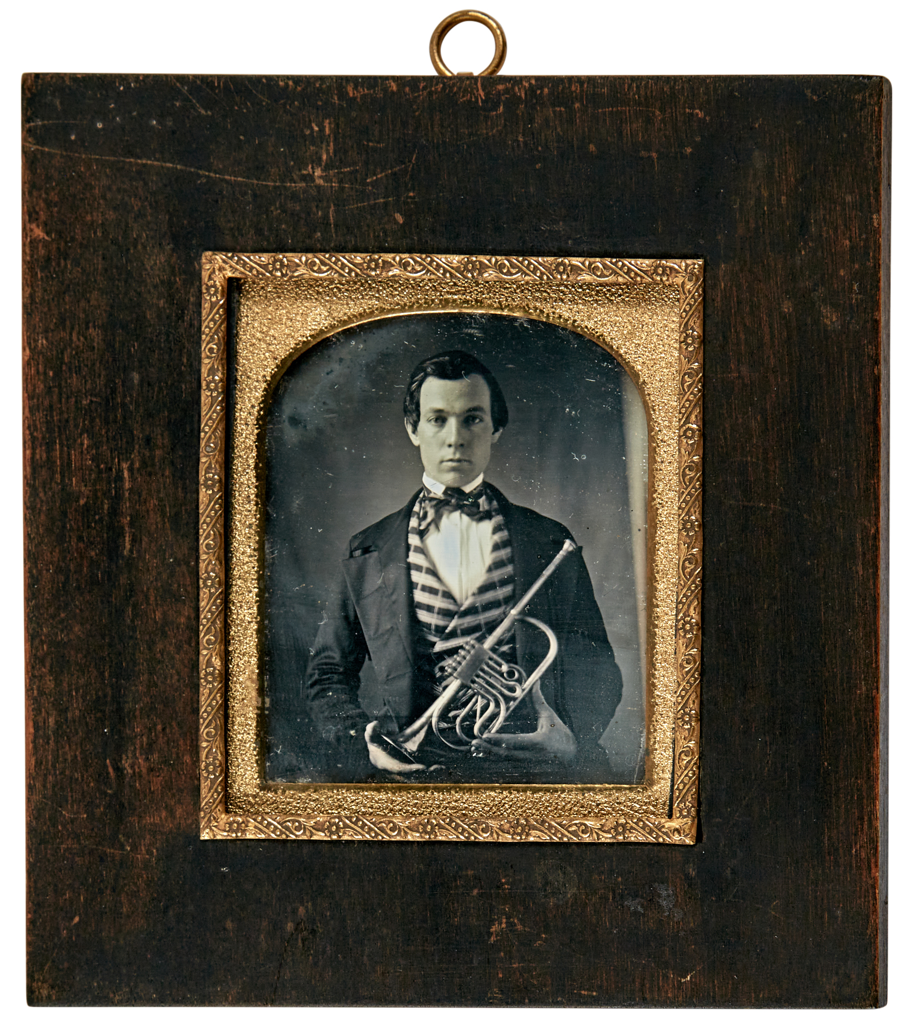 Lot image - [DAGUERREOTYPE-MUSICIANS]  Daguerreotype of man with brass instrument (six-valve trumpet).