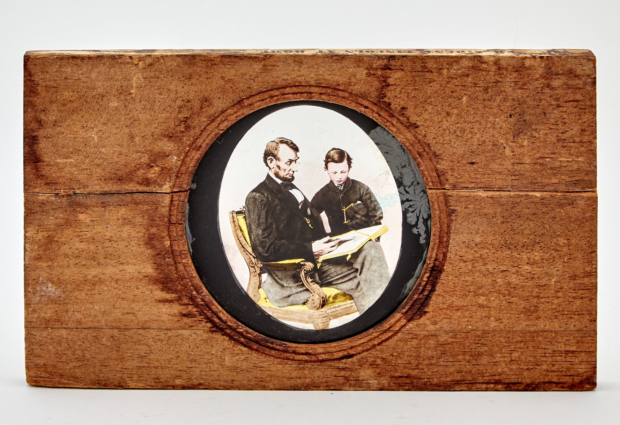 Lot image - [LINCOLNIANA]  Ten framed pieces relating to Lincoln, both prints and photographs, along with a plaster cast of Lincolns hand and three magic lantern slides.