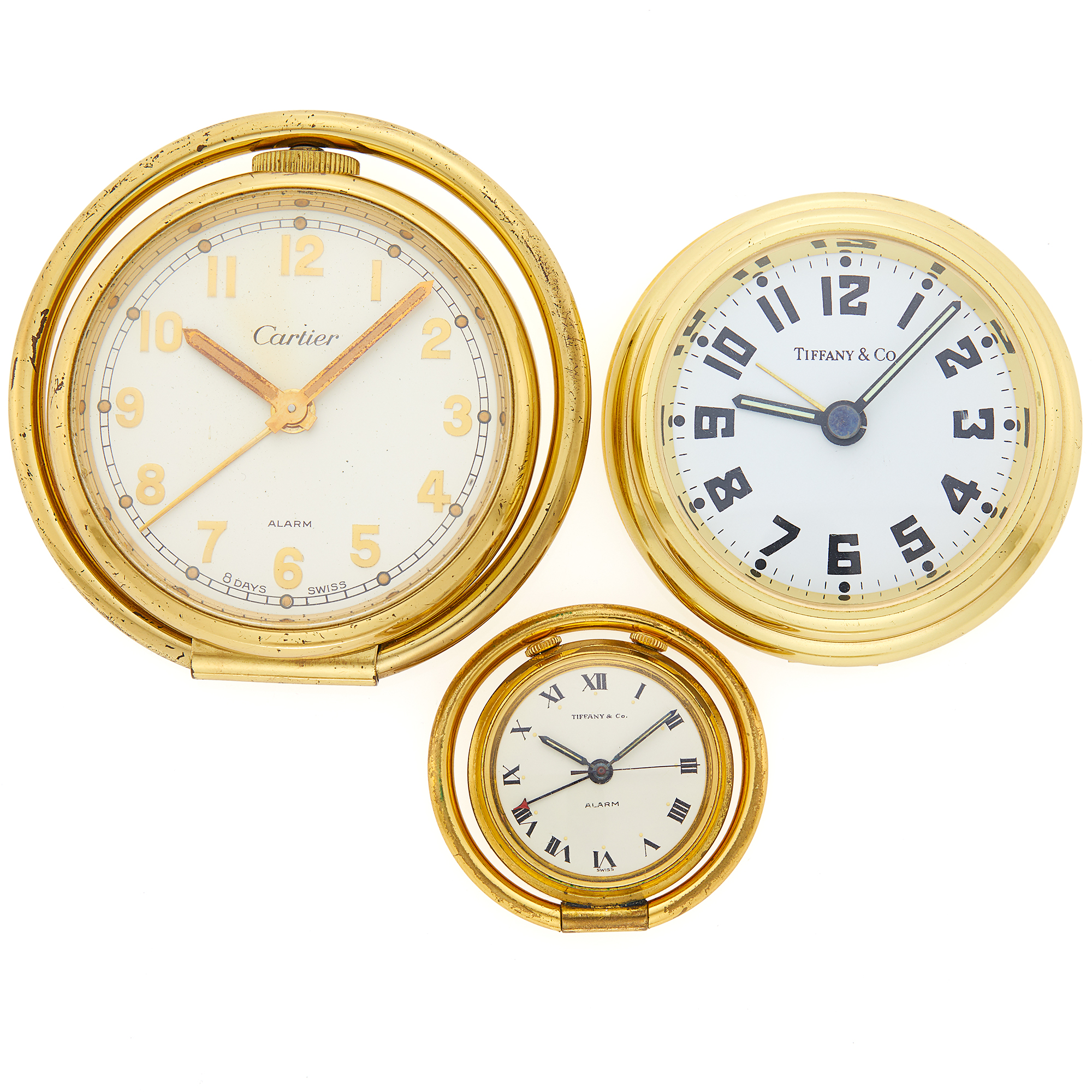 Lot image - Three Cartier and Tiffany & Co. Gilt-Metal Travel Clocks