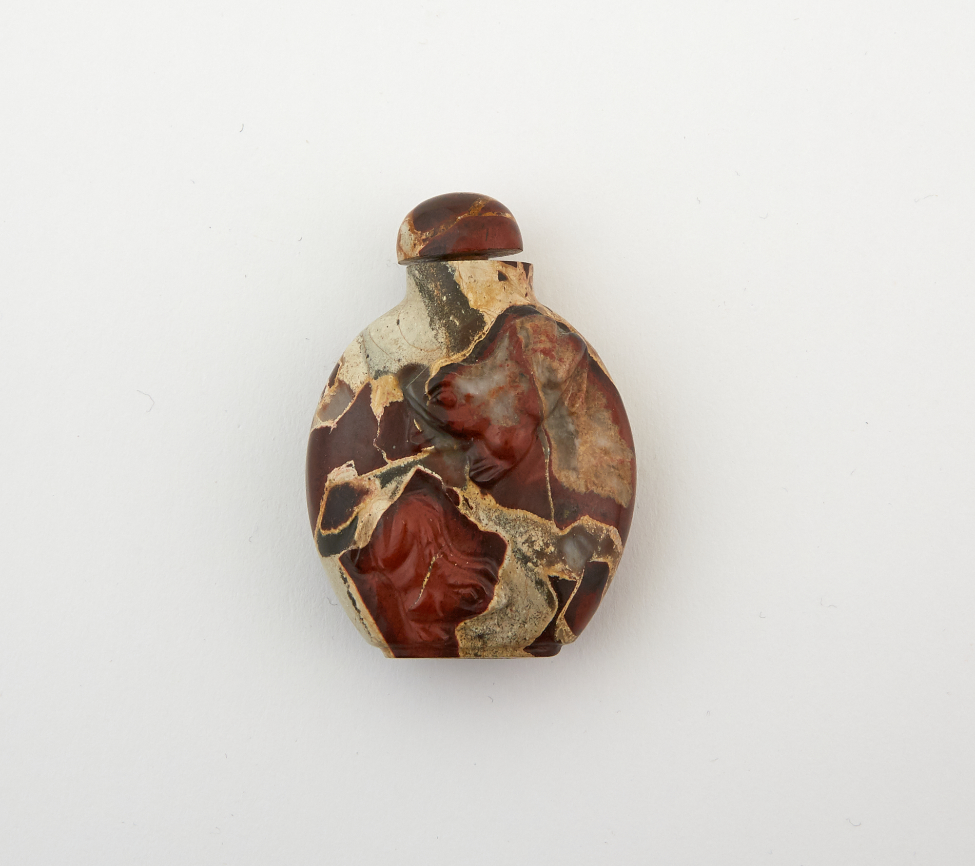 Lot image - A Chinese Carved Variegated Hardstone Snuff Bottle