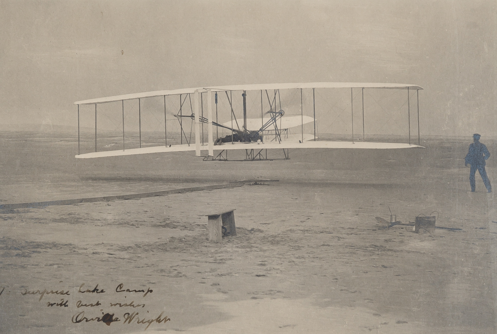 Lot image - WRIGHT, ORVILLE  Inscribed photograph showing the first flight of the Wright Flyer I on December 17, 1903.