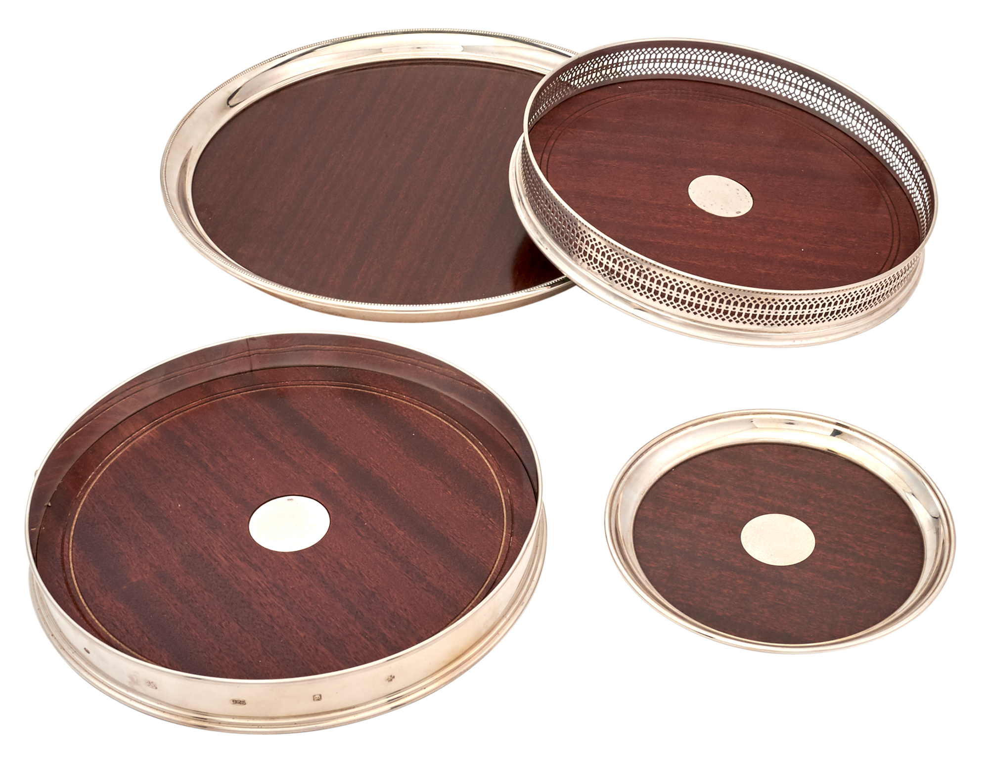 Lot image - Four Sterling Silver and Mahogany Graduated Drinks Trays