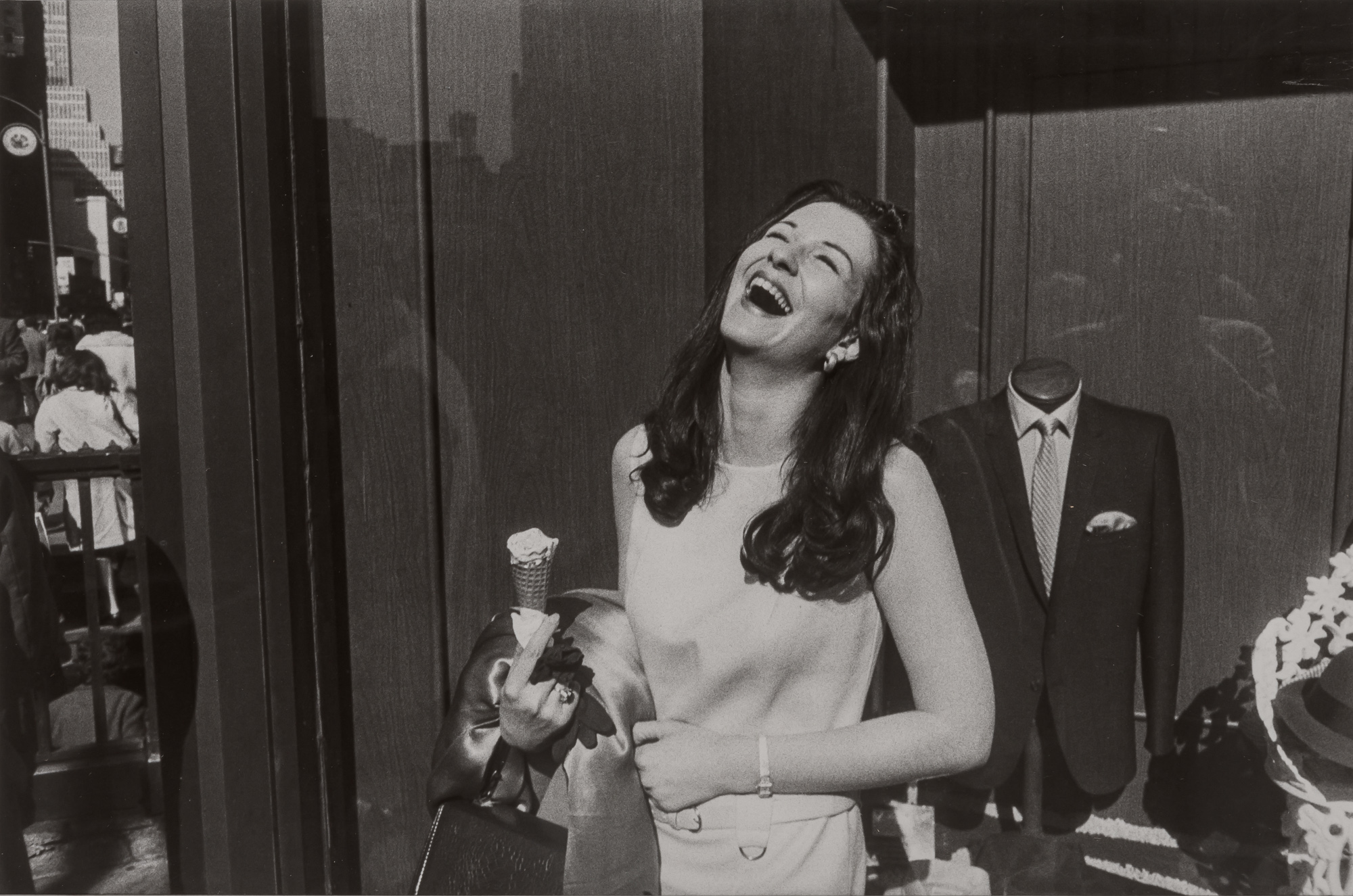 Lot image - WINOGRAND, GARRY (1928-1984)  [Laughing Woman with Ice Cream Cone], image from Women are Beautiful,