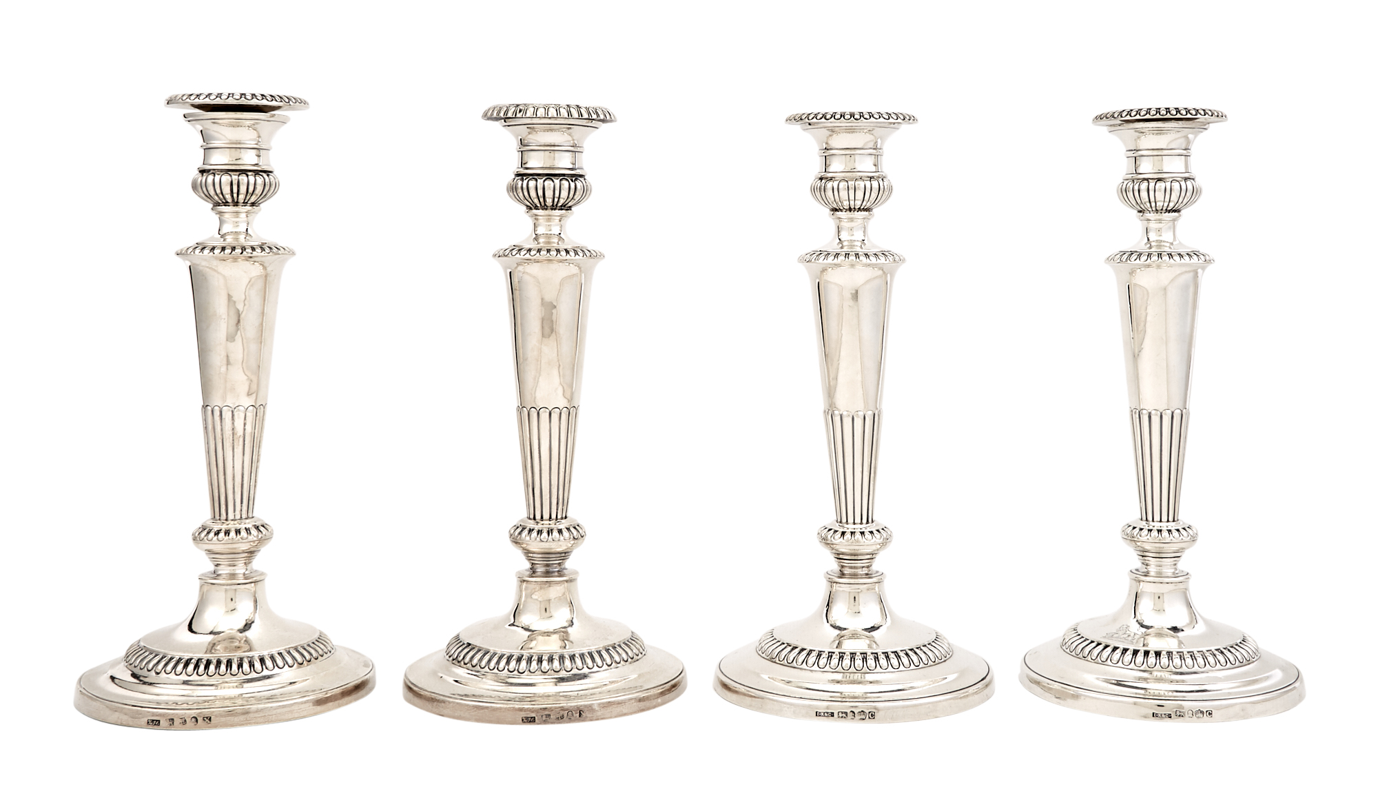 Lot image - Assembled Set of Four George III Sterling Silver Candlesticks