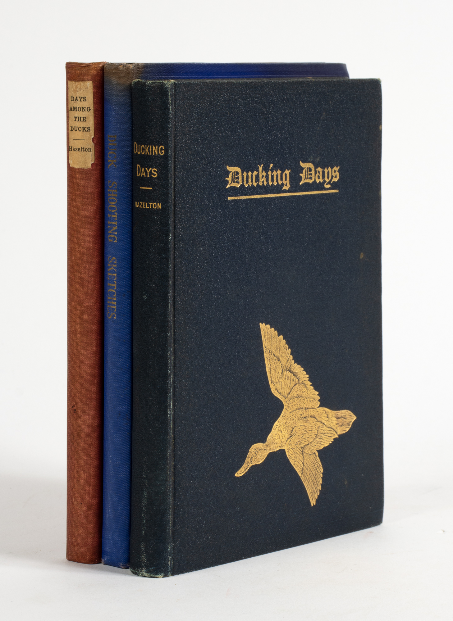 Lot image - [AMERICA-HUNTING]  HAZELTON, WILLIAM C. Three works written or compiled by him.  Includes Ducking Days. Narratives of Duck Hunting, Studies of Wildfowl Life, and Reminiscences of Famous Marksmen on the Marshes and at the Traps.