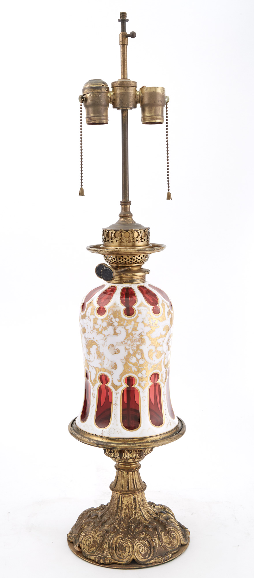Lot image - Bohemian Style Gilt-Metal Mounted and Gilt Decorated Opaque White and Ruby Overlay Glass Lamp