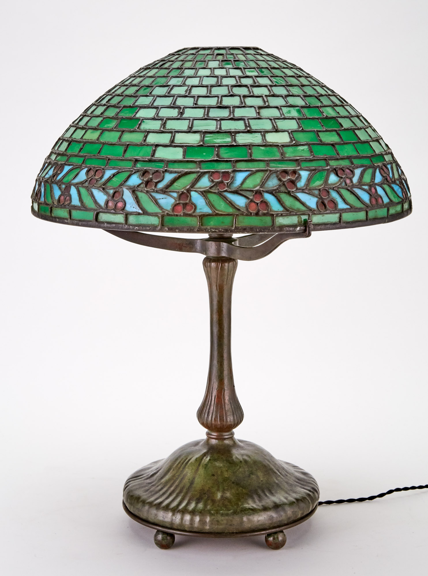 Lot image - American Patinated Metal and Leaded Glass Geometric and Leaf and Berries Table Lamp