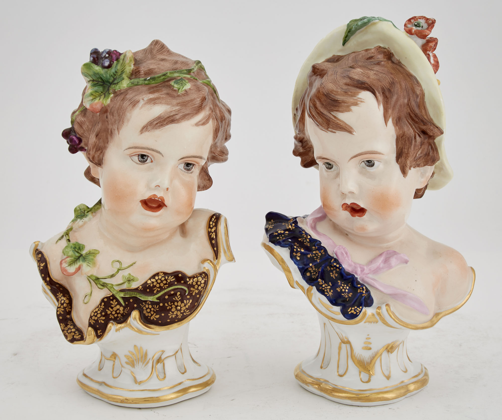 Lot image - Pair of Continental Painted Porcelain Busts of Children