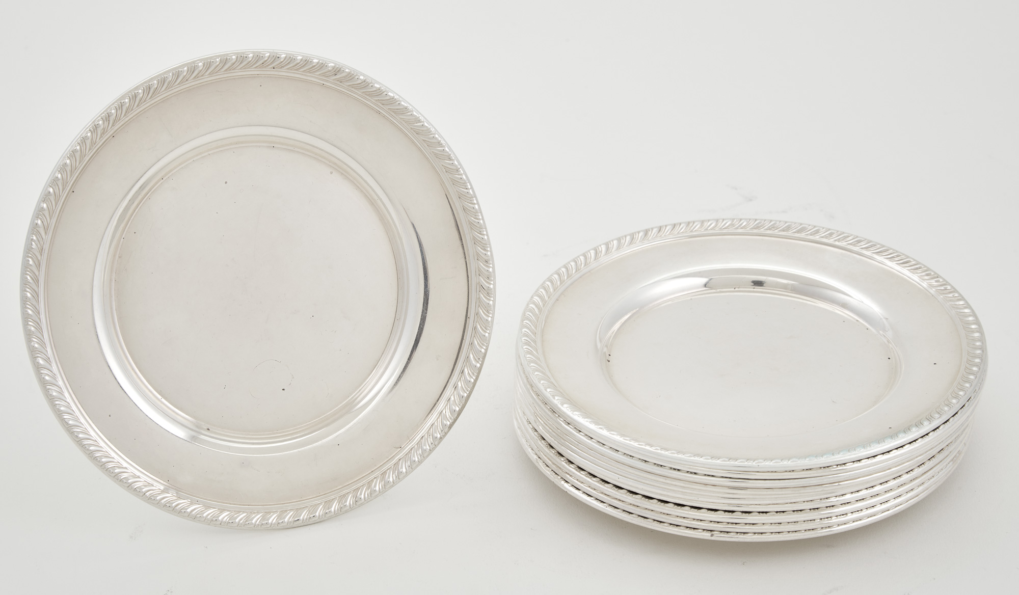 Lot image - Set of Twelve Sterling Silver Butter Plates
