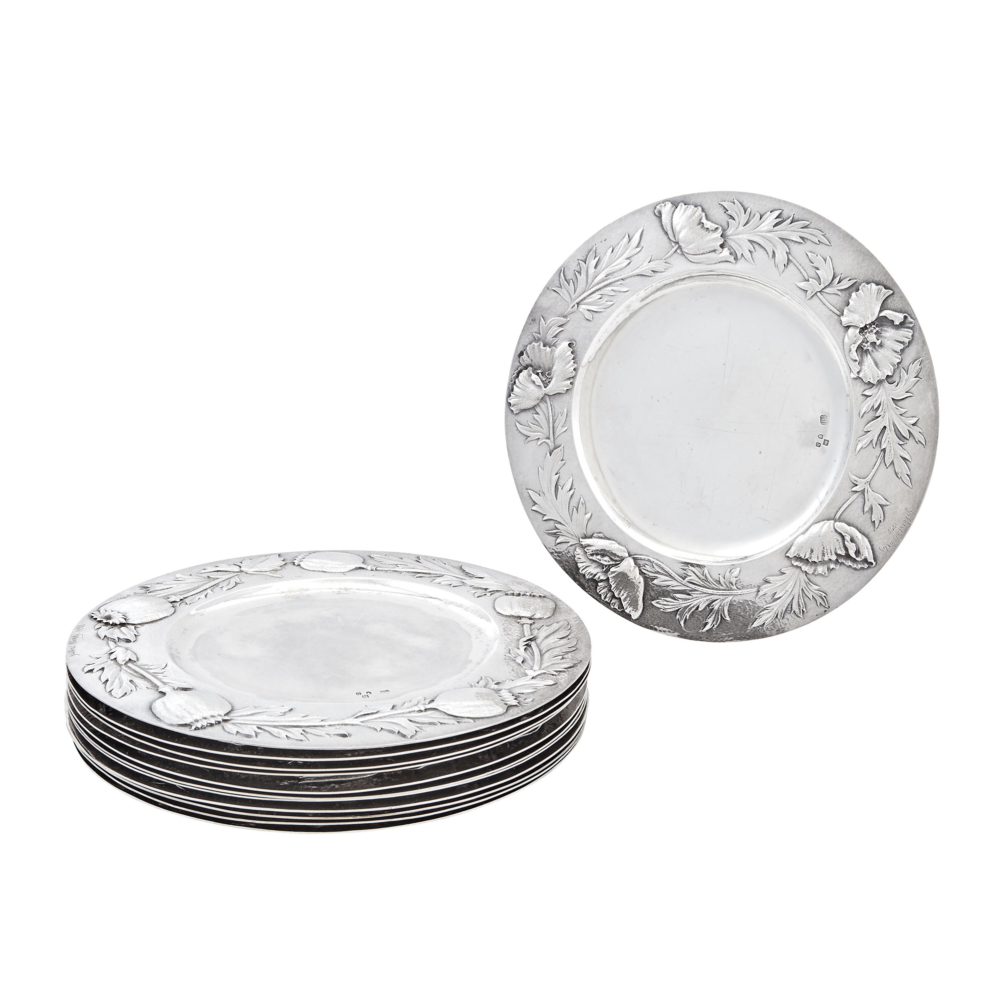 Lot image - Set of Twelve English Sterling Silver Chargers    Gilbert Marks, London, 1897  Each circular, the border embossed with floral specimen and incised signature and date 1898.  Diameter 8 5/8 inches, total approximately 122 ounces.