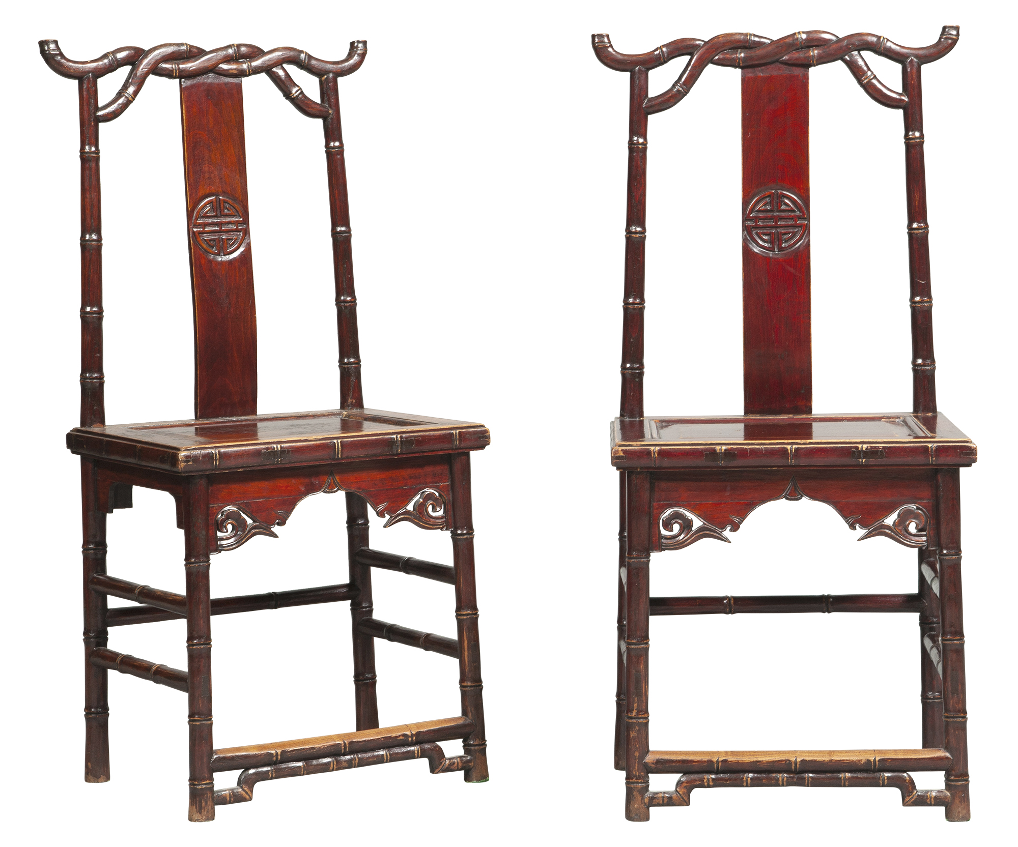 Lot image - A pair of Chinese carved softwood twisted bamboo sidechairs  Early 20th century   The crest rail, rear posts, legs, and aprons carved in imitation of bamboo, the back splat carved with a shou medallion  . Some areas of wear