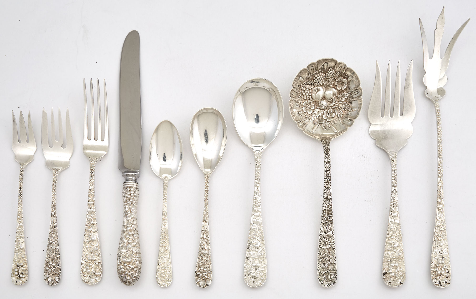 Lot image - Steiff Sterling Silver Floral Repoussé Flatware Service; Together with an S. Kirk & Son Sterling Silver Serving Spoon