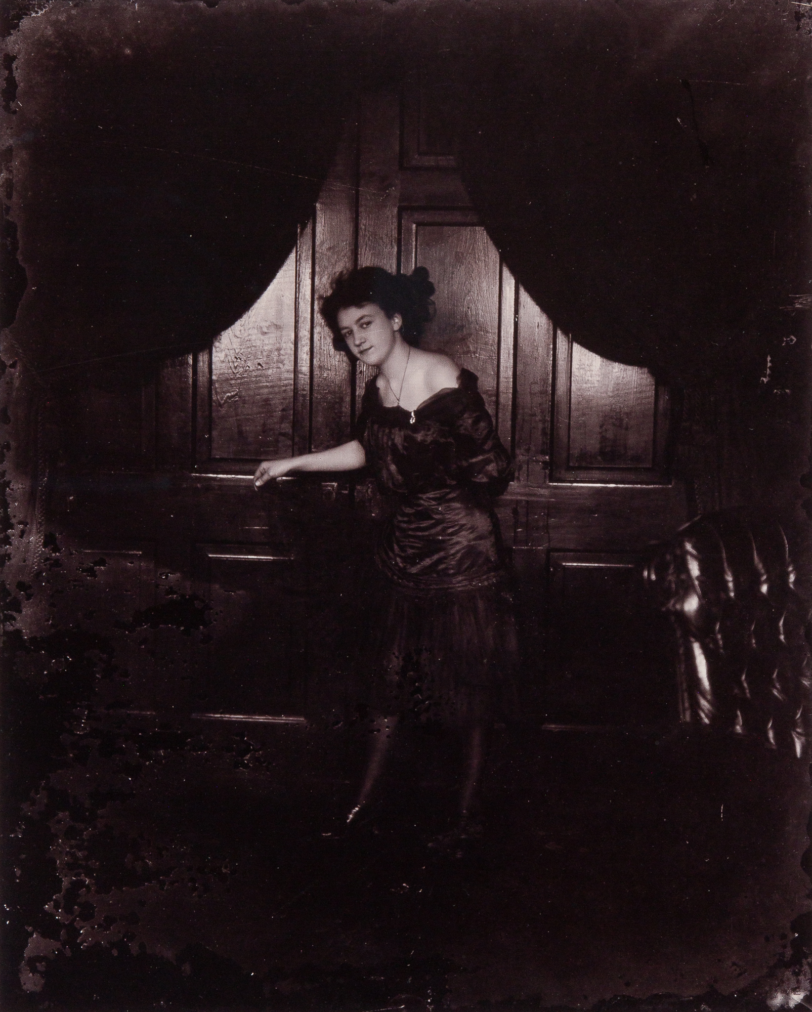 Lot image - BELLOCQ, E. J. (1873-1949)  [Storyville portrait, New Orleans, woman standing before paneling],